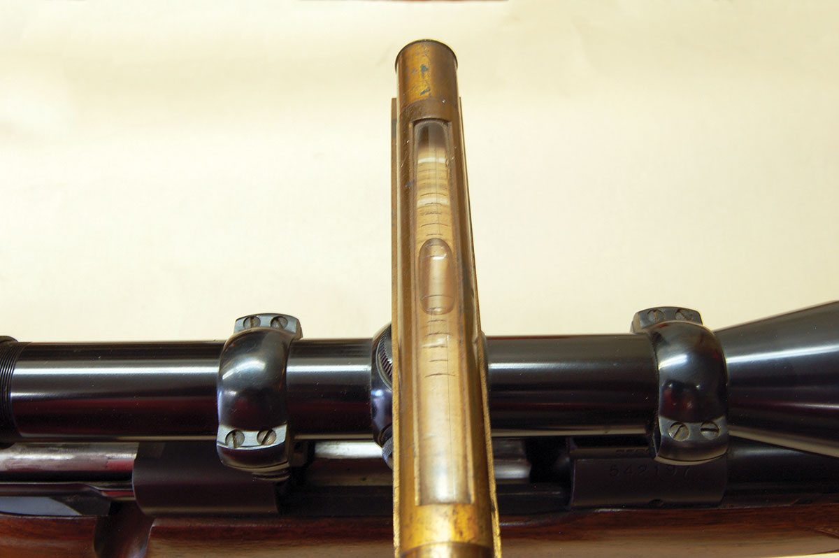 Once the rifle is leveled and locked in place, the level is placed on an elevation turret cap. The ring screws are loosened and the scope is turned until it is level.